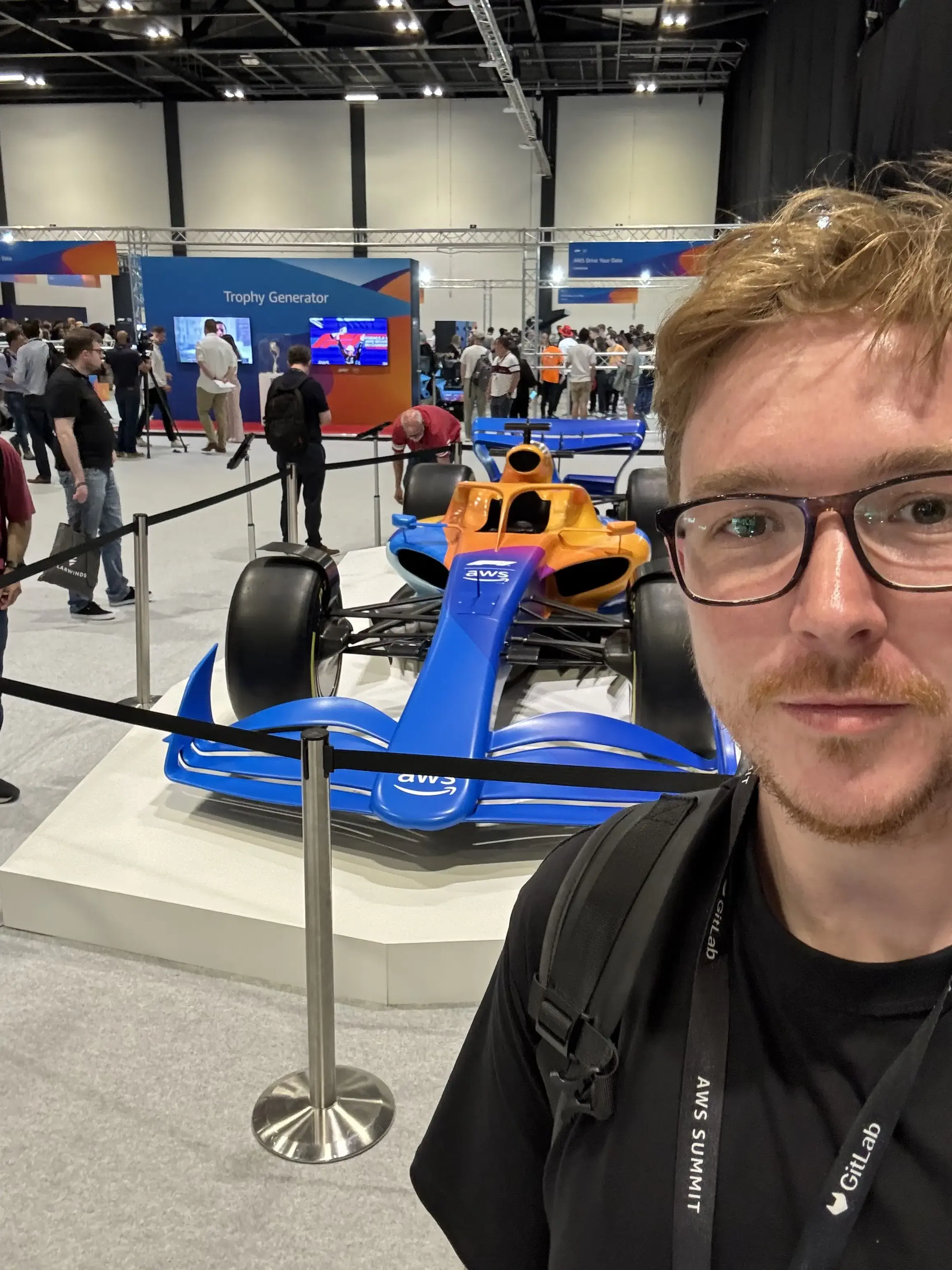 selfie at AWS Summit London in front of an F1 car